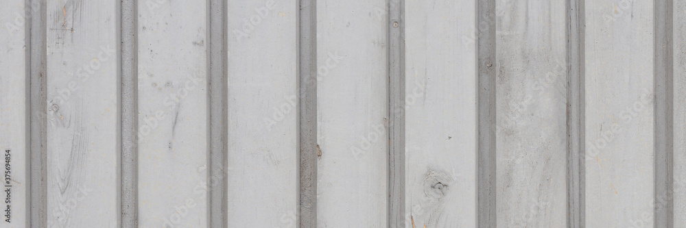 Wood texture. Fence from gray wooden planks. Wooden wall. Wide panoramic rustic texture for background and design.