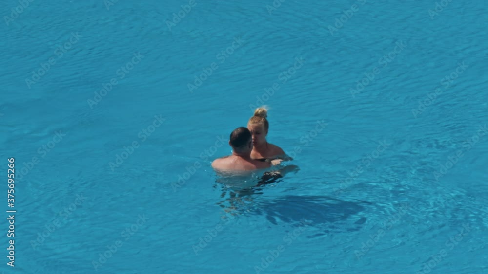Beautiful young people having fun in swimming pool Beautiful young people having fun in swimming pool
