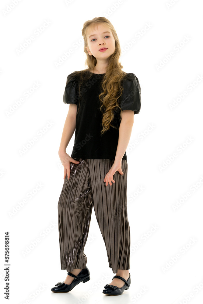 Cute little girl in a pantsuit. Isolated on a white background. Cute little girl in a pantsuit. Isolated on a white background.