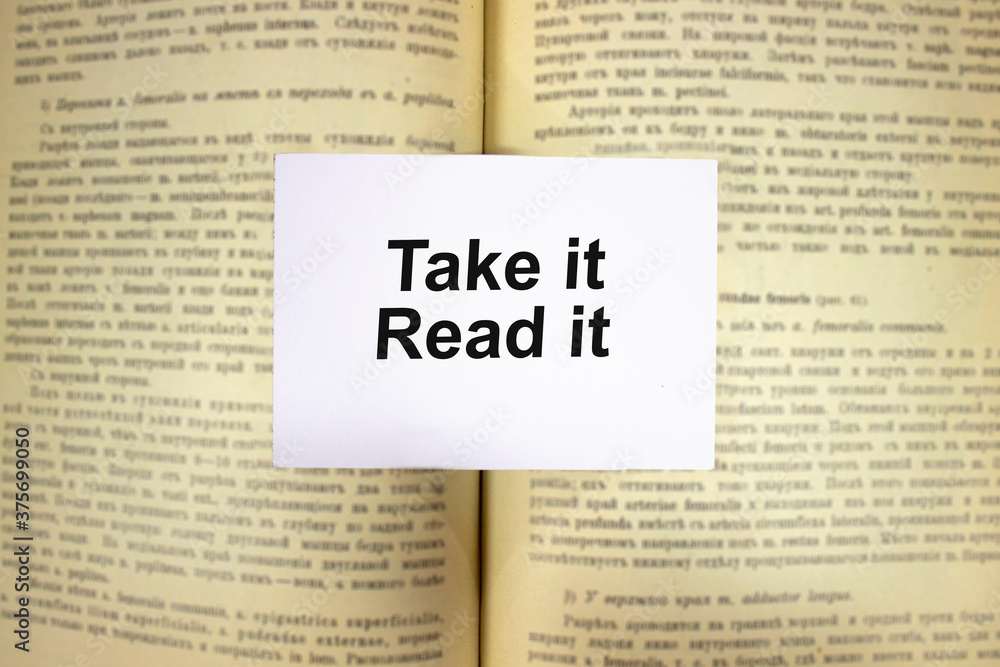 Obraz premium Take it, read it written in white note on open book