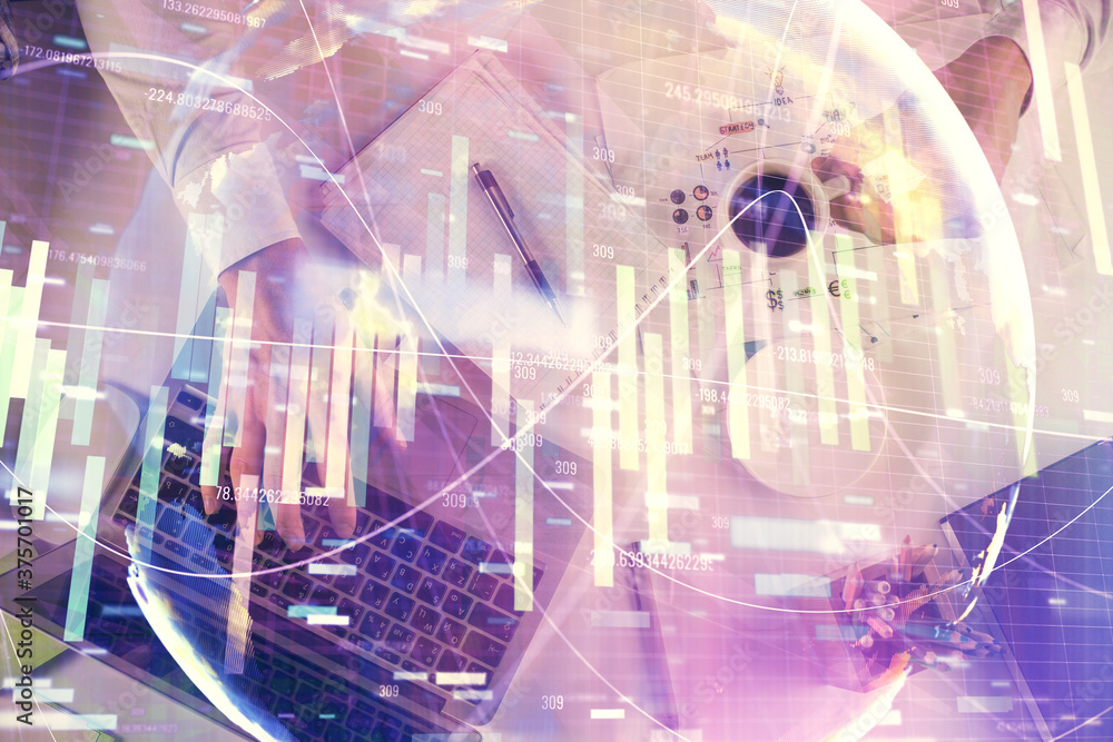 Double exposure of man's hands typing over computer keyboard and business theme hologram drawing. Top view. Financial markets concept. Double exposure of man's hands typing over computer keyboard and business theme hologram drawing. Top view. Financial markets concept.