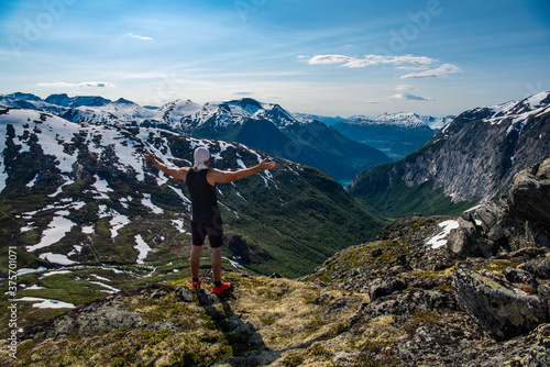 Man standing on mounain top in Norway
