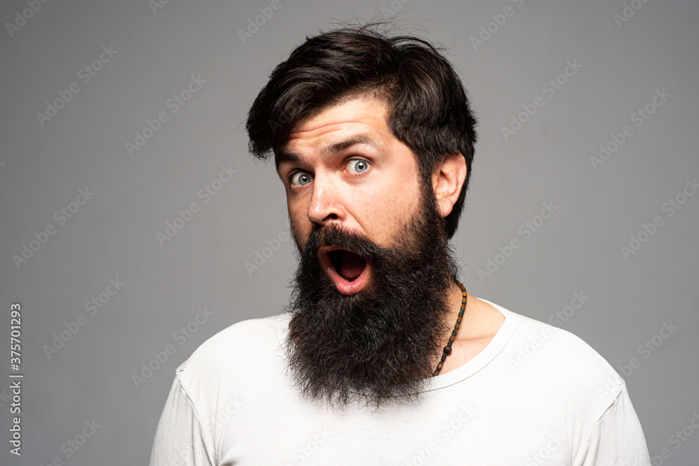 Obraz premium Surprised handsome bearded man in shocked. Surprise expression, wow amazed excited face. Emotions people concept.