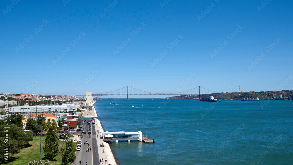 Portugal. Lisbon. Panorama to the east from the Belém Tower observation deck. The Monument to the Discoverers is visible, behind it is the Bridge of April 25 and the Statue of Christ