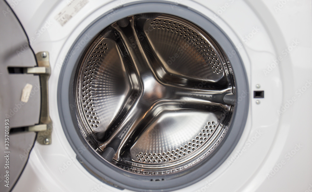 Washing machine, close-up image, drum from the machine is sifting, cleanliness of the machine and clothes