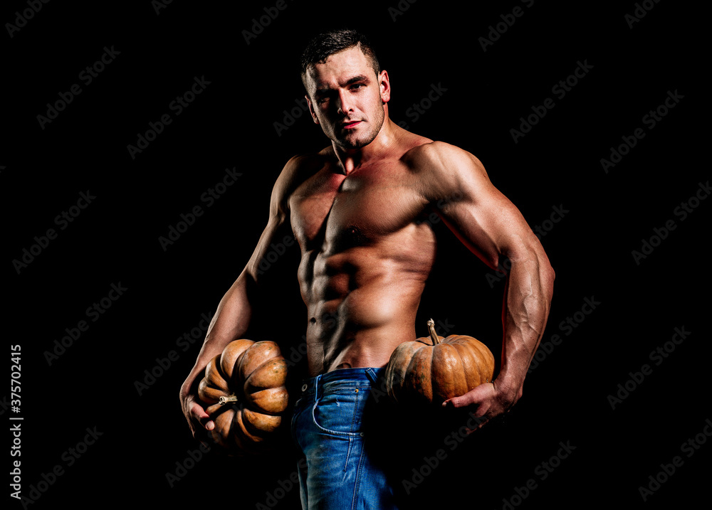 Halloween sale and shopping. Fashion guy with sexy naked torso hold pumpkin.