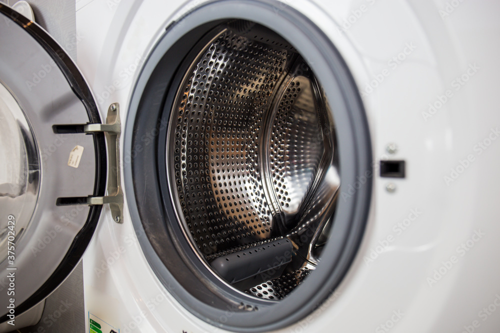 Washing machine, close-up image, drum from the machine is sifting, cleanliness of the machine and clothes Washing machine, close-up image, drum from the machine is sifting, cleanliness of the machine and clothes