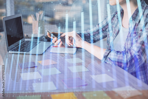 Double exposure of businesswoman hands typing on computer and forex graph hologram drawing. Financial analysis concept.