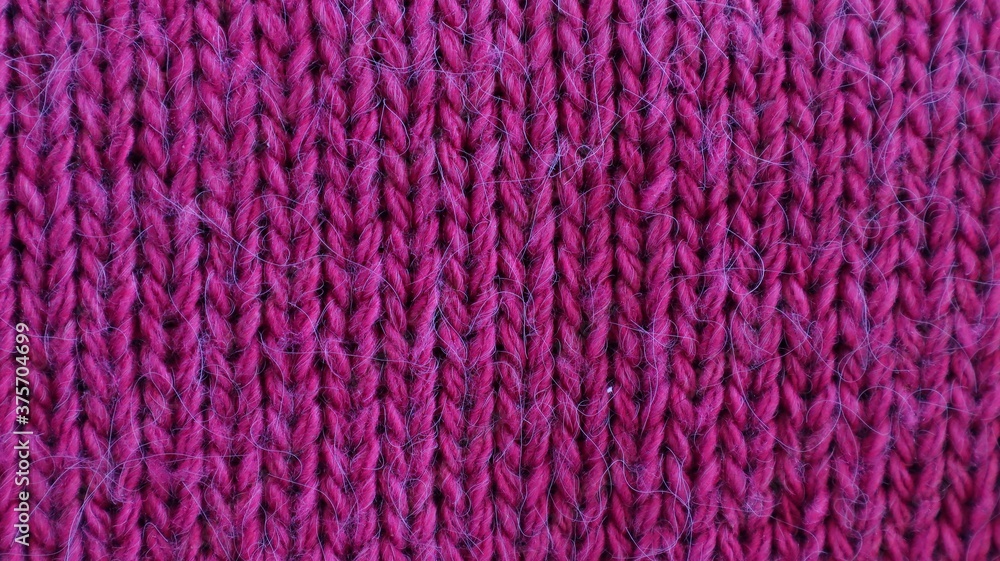 Background texture knitting pattern purple fabric close-up