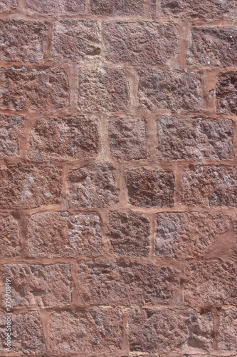Old medieval red stone wall texture