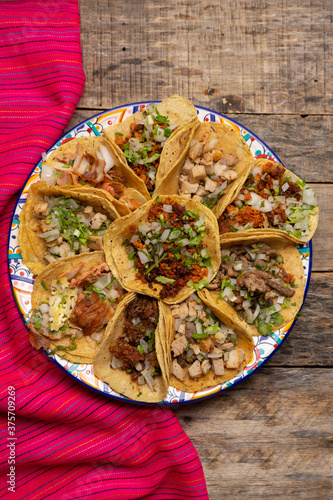 Assortment of mexican tacos on wooden background