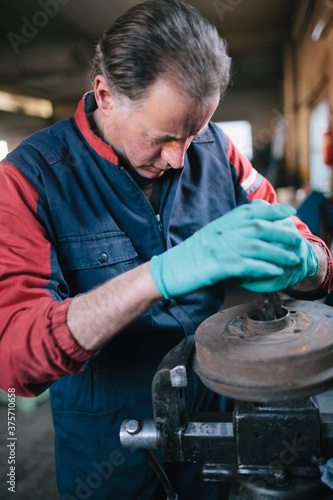 Mechanic working in auto repair shop photo