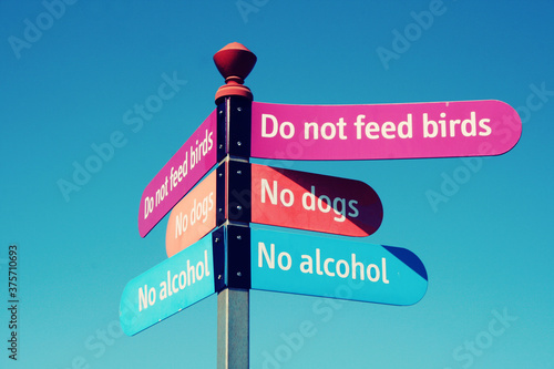 Lots of rules on a sign forbidding people to have dogs or feed birds