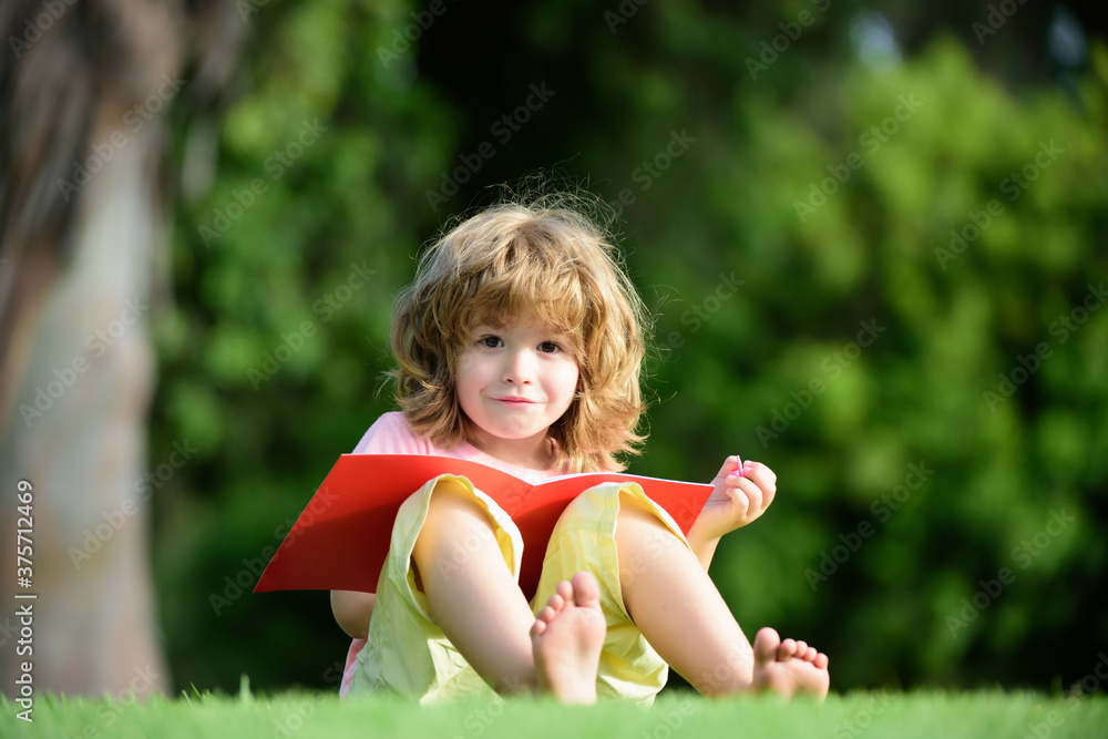 Distance education. Kid pupil boy doing homework for school in park. Distance education. Kid pupil boy doing homework for school in park.