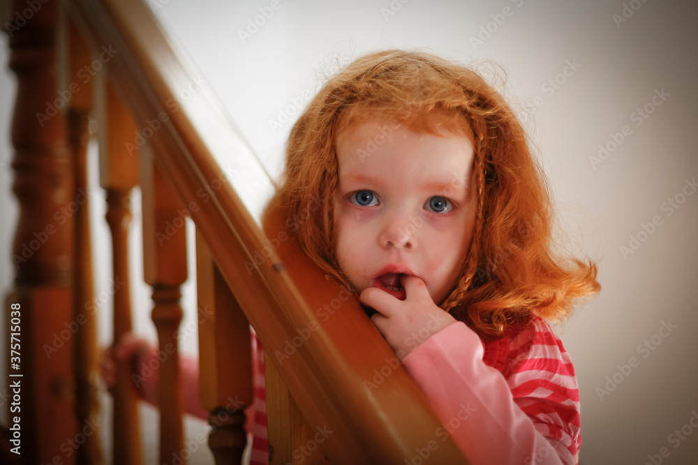Little girl crying on stairs at home Little girl crying on stairs at home