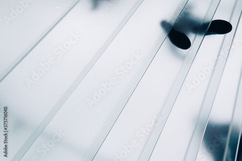 People on a glass stairway photo