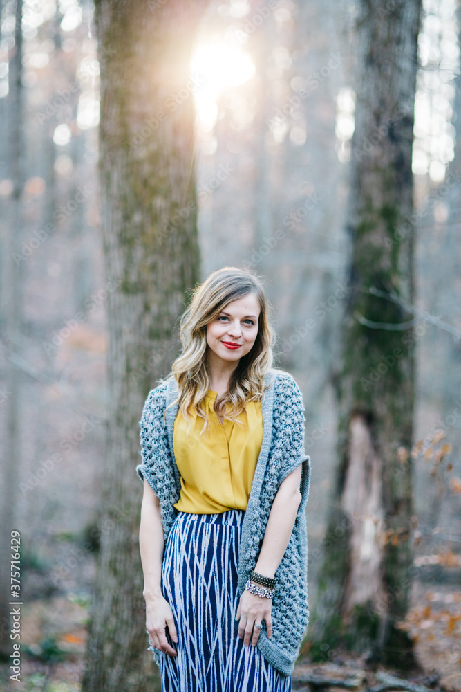 Fashionable and stylish woman standing in a forrest Fashionable and stylish woman standing in a forrest