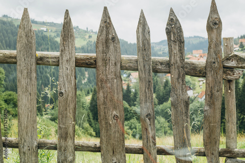 Handmade brown wooden fence overlooking mountain scenery photo