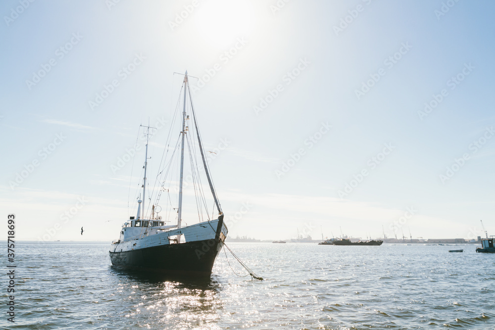 Sailboat on the sea near harbour on a sunny day Sailboat on the sea near harbour on a sunny day