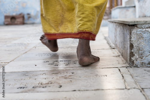 A man walking barefoot in a temple photo