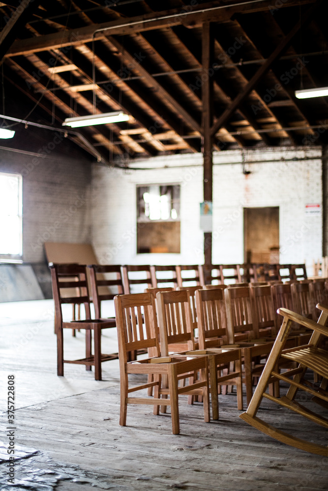 Chairs lined up in rows in a warehouse workshop Chairs lined up in rows in a warehouse workshop