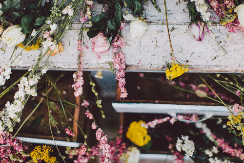 Dried out flowers laying on a white dress