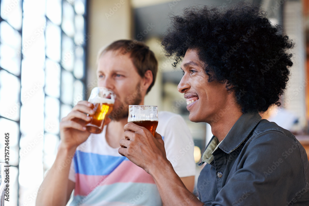 Friends drinking beer alcohol at a pub Friends drinking beer alcohol at a pub