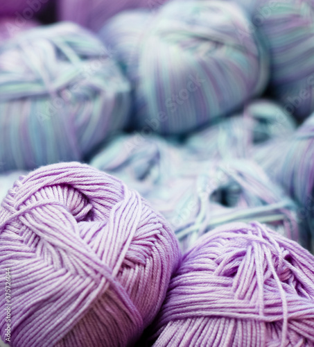 Colorful balls of purople and blue yarn photo