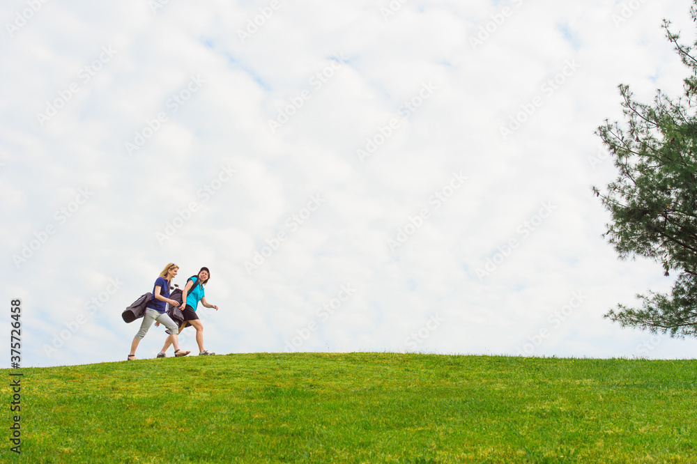 Friends Golfing Together Walk Along Ridge Line on Course Friends Golfing Together Walk Along Ridge Line on Course