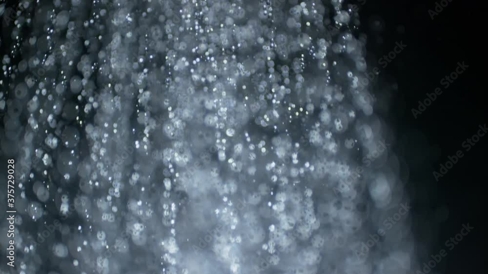 Macro Close Up of a fountain of water droplets as concept shot for purity and vitality health cleanyness and beauty product template backgrounds. Highspeed studio shot. Macro Close Up of a fountain of water droplets as concept shot for purity and vitality health cleanyness and beauty product template backgrounds. Highspeed studio shot.