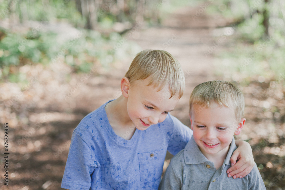 Smiling brothers looking down Smiling brothers looking down