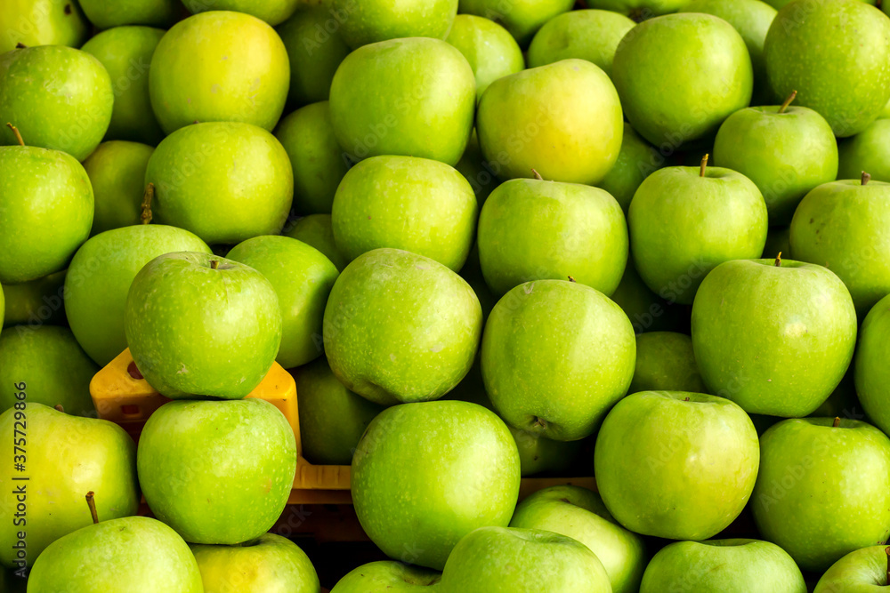 Ripe,fresh green apples heap at market,close up taken Ripe,fresh green apples heap at market,close up taken