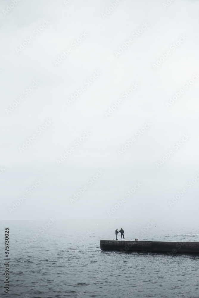 Sea landscape, lonely people on a pier