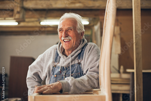 Smiling Carpenter at His Workshop photo