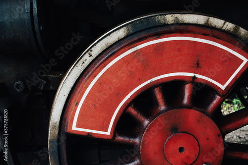 Driving wheel on an old steam engine photo