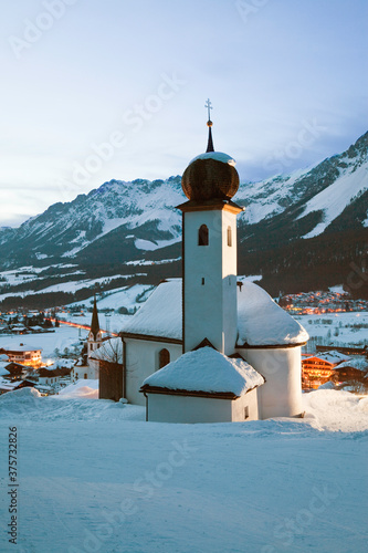 Church illuminated at night overlooking Ellmau ski resort, part of the giant Ski Welt area, Wilder K photo