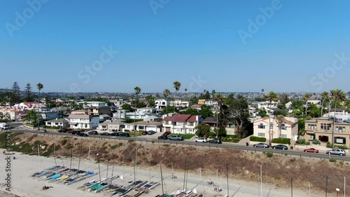 Aerial view of Mission Bay and beaches with sailboat in San Diego, California. USA. Community built on a sandbar with villas and recreational Mission Bay Park. Californian beach-lifestyle. photo