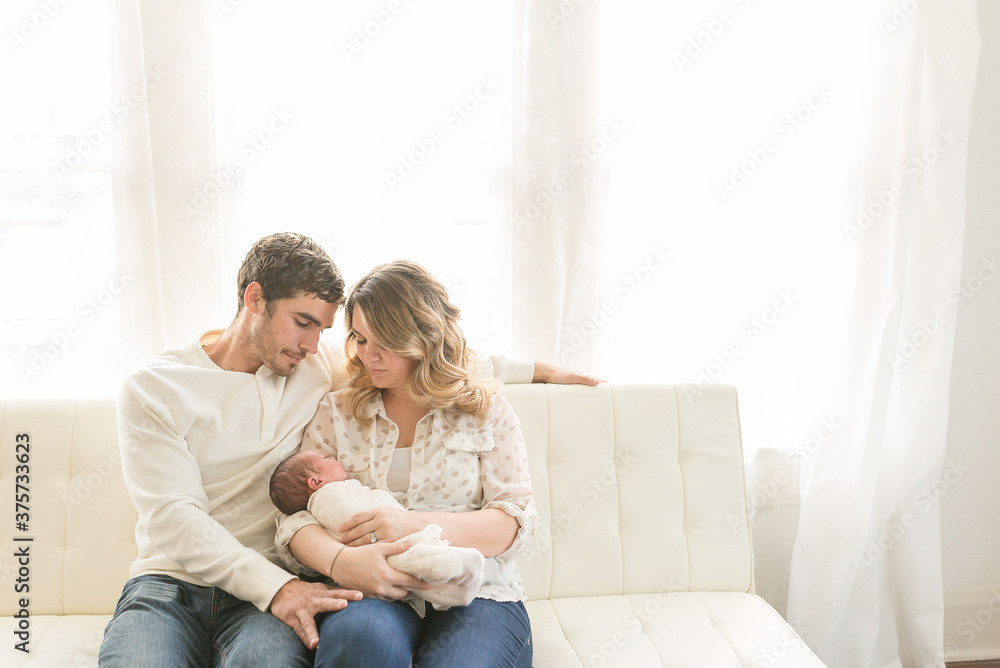 A Mom And Dad Hold Their Newborn Baby Boy A Mom And Dad Hold Their Newborn Baby Boy
