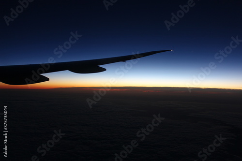 airplane flying over the sunset