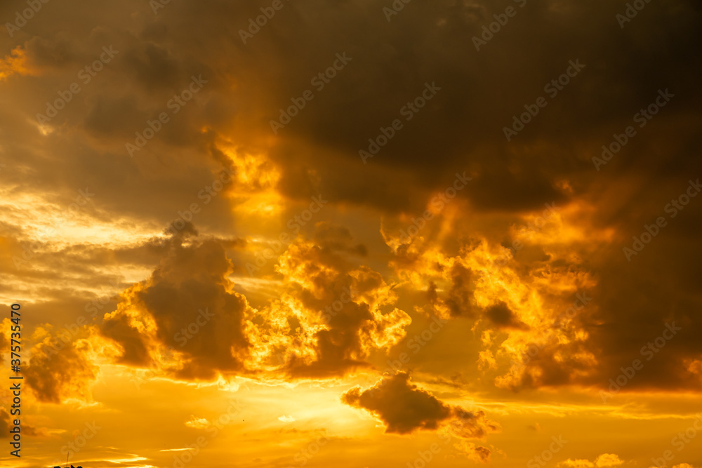 Sunset, bright sky with golden clouds.