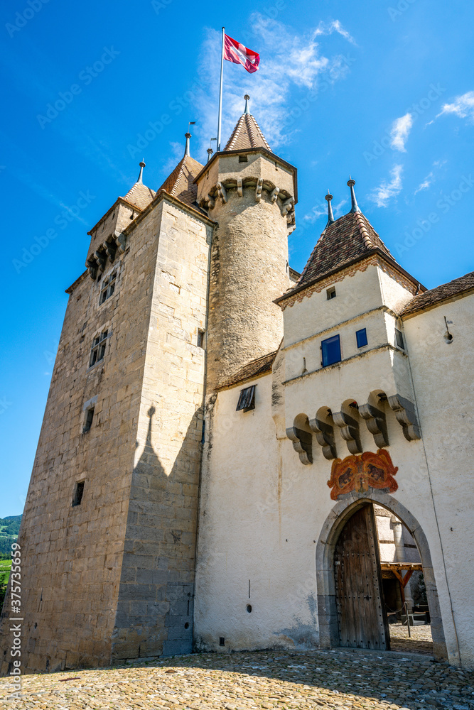 Vertical view of entrance gate and tower of Aigle castle in Switzerland