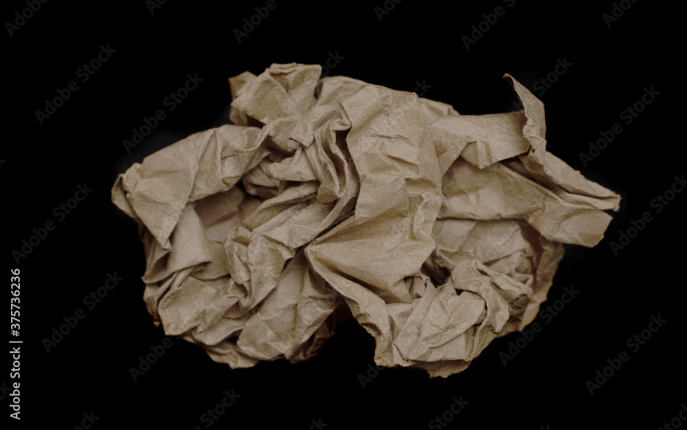 Crumpled cardboard bag on a black background. Crumpled cardboard bag on a black background.