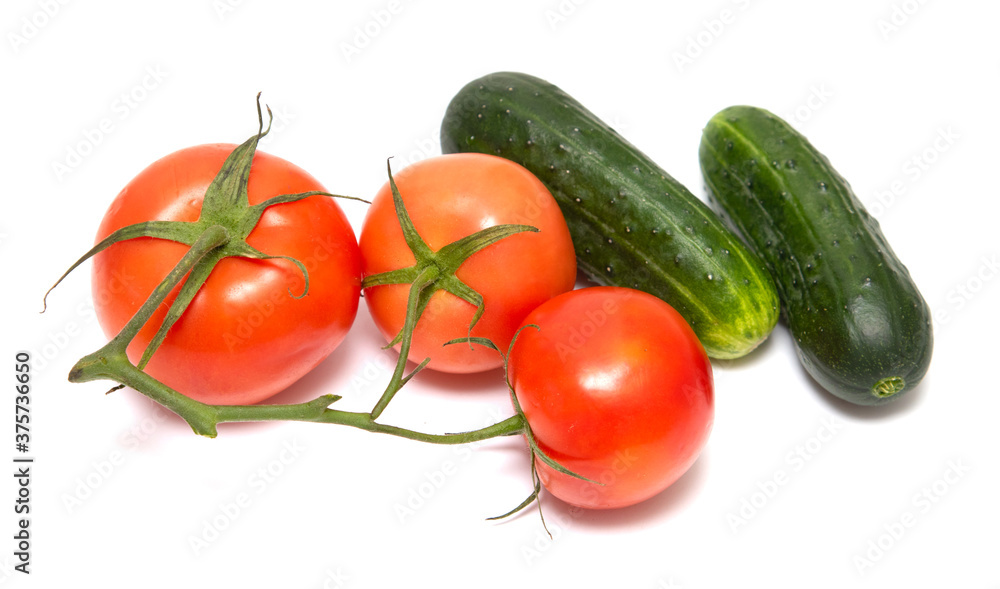 Red tomato and green cucumber isolated on a white background. Red tomato and green cucumber isolated on a white background.