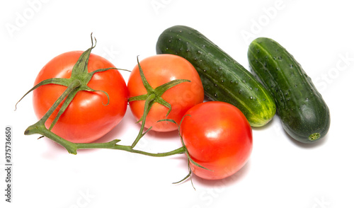 Red tomato and green cucumber isolated on a white background.