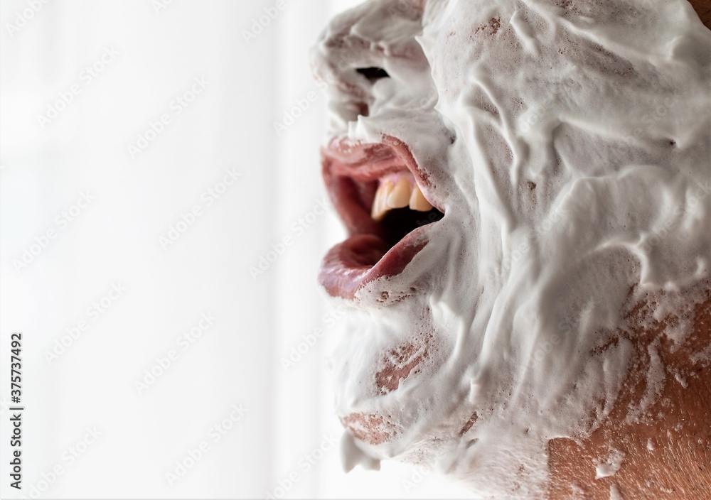 Male face in shaving disinfectant soap.