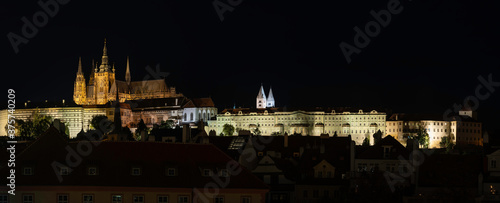 
panorama of illumination of Prague castle and church of St. Vitus at night. in the center of prague in the czech republic there are visible lights from street lighting and on the surface of the river