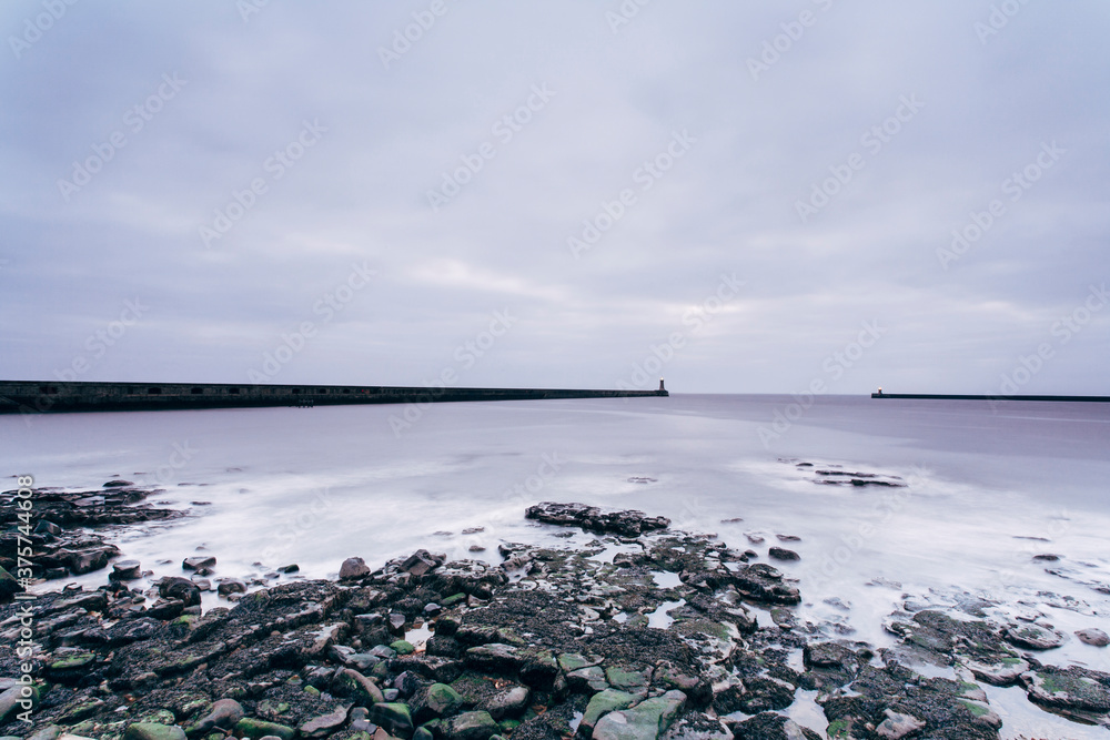 Lighthouse and breaking waves at dawn. Tynemouth, Northumberland, UK. Lighthouse and breaking waves at dawn. Tynemouth, Northumberland, UK.