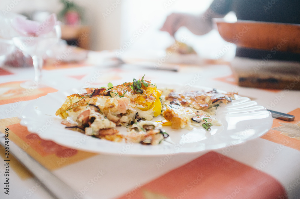 Serving cooked eggs with ham and herbs on the pan Serving cooked eggs with ham and herbs on the pan
