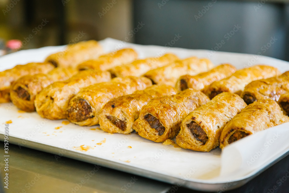 Tray of warm takeaway sausage rolls Tray of warm takeaway sausage rolls