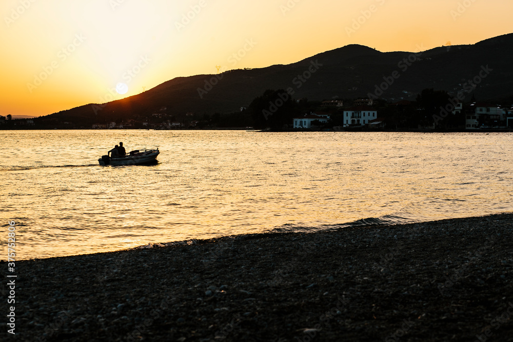 Fishing boat by sunset in Greece Fishing boat by sunset in Greece